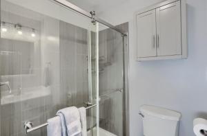 a white bathroom with a shower and a toilet at 15 off Summer Special - Wifi - Pet Friendly in Sigel +48 photos