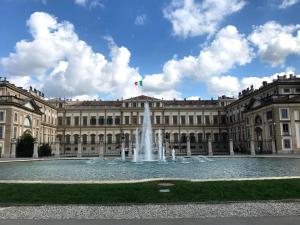 a large building with a fountain in front of it at CASABELLA in Monza