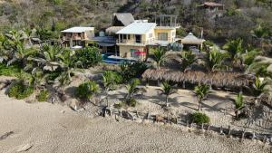 an aerial view of a house on the beach at Casa Obe in Yolina