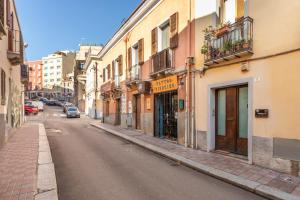 an empty street in a city with buildings at Black & White in Cagliari