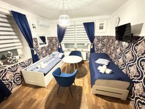 a bedroom with a bed and a desk and a table at Ubytování U Synagogy Dobříš in Dobříš