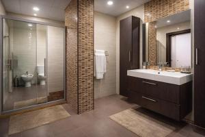 a bathroom with a sink and a toilet at Al Basem Hotel in Amman +44 photos
