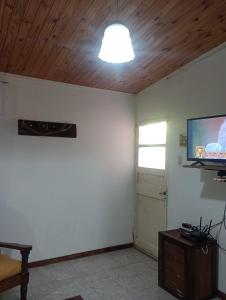 a living room with a flat screen tv on the wall at En Santa Rosa in Santa Rosa