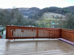a wooden deck with a bench on top of it at Apartmány U GUNÁRA Vyhne - Apartmán Akácia in Vyhne +2 photos