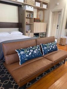 a couch with two pillows on it in a bedroom at Romantic Studio Apt in Historic Downtown Savannah in Savannah +23 photos
