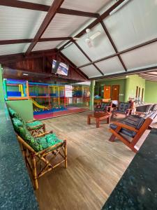 a room with chairs and a play area with water at Pousada Arco Iris Fortaleza in Fortaleza
