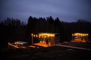 a building with lights on it at night at Дзеркальний будинок Botan in Malaya Bugayevka +21 photos