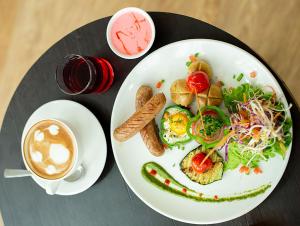 a plate of food and a cup of coffee at Hotel Sabrina Kathmandu in Kathmandu +85 photos