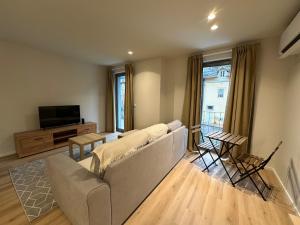 a living room with a couch and a television at Varandas do Gerês in Geres