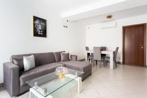 a living room with a couch and a table at Black & White in Cagliari