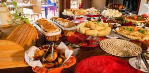 a table topped with lots of different types of food at Pousada Bicho Preguiça in Pipa +40 photos
