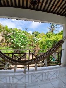 a hammock on a balcony with a view at Casa charme pipa in Pipa