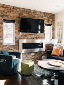 a living room with a tv on a brick wall at Lakefront - Trails - Skiing - Views - Georgetown in Georgetown