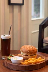 a hamburger and french fries and a drink on a table at Udaigarh Palace - The Heritage Hotel in Jodhpur