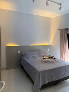 a bedroom with a bed with a table on it at Kit Gonzaga Santos in Santos