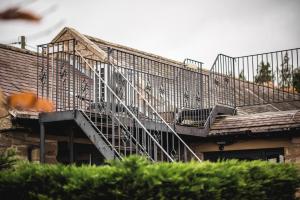 a metal staircase on the side of a building at Dykeneuk rooms in Hartburn
