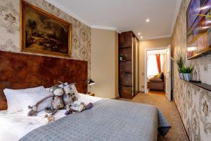 a bedroom with a bed with stuffed animals on it at BridgeStoneLuxApart Free Parking in Riga