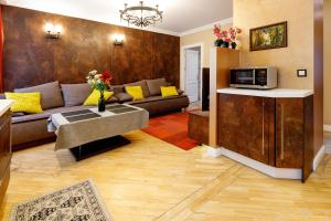 a living room with a couch and a table at BridgeStoneLuxApart Free Parking in Riga