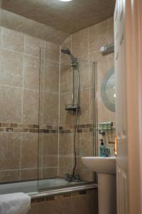 a bathroom with a shower and a tub and a sink at Dykeneuk rooms in Hartburn +27 photos