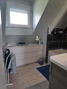 a bathroom with a sink and a window at Kastell-Mor 2 chambre d'hôtes à Santec in Santec