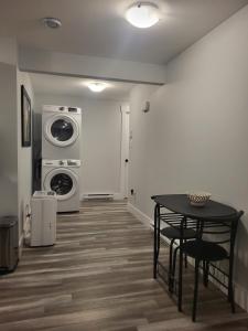 a laundry room with a table and a washer and dryer at Peace Home in Dieppe