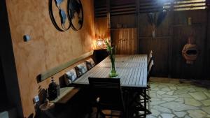 a table with a vase on it in a room at Le Logis Du Four in Soudan