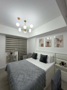 a bedroom with a large bed and a ceiling fan at Azure North - Aurora Sky in San Fernando +16 photos