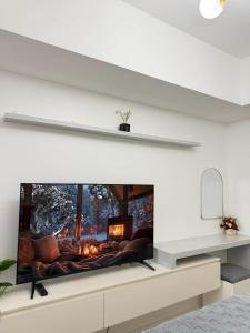 a fireplace in a living room with a white wall at Azure North - Aurora Sky in San Fernando