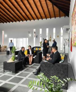 a group of people sitting in chairs in a lobby at Hotel Kariña Punta de Mata in Punta de Mata