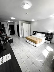 a hotel room with a bed and a table and a desk at Hotel Kariña Punta de Mata in Punta de Mata