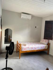 a bedroom with a bed and a camera in a room at Casa Mosqueiro, Praia do Farol e Chapéu Virado in Mosqueiro
