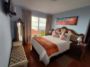 a bedroom with a large bed and a large window at Golden Sun Refugio -Calheta in Estreito da Calheta