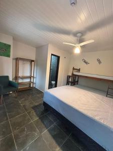 a bedroom with a bed and a ceiling fan at Pousada NativaMar in Guaratuba +26 photos