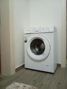 a white washing machine sitting in a room at Anatoli's house in Kastoria