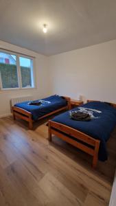 a bedroom with two beds and a window at La désirée in Blangy-sur-Bresle