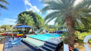 a swimming pool with a slide and a palm tree at เกาะช้าง พูลวิลล่า วิวทะเล 2 in Trat