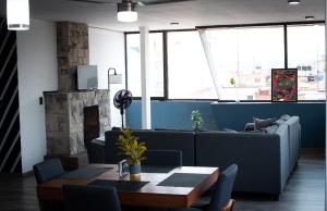 a living room with a couch and a fireplace at Deluxe Loft Air Conditioning Downtown Parking in Tepatitlán de Morelos