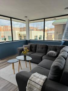 a living room with a couch and a table at Deluxe Loft Air Conditioning Downtown Parking in Tepatitlán de Morelos