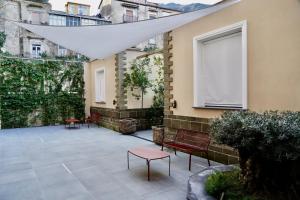 a patio with chairs and a table and a window at Prince Residence in Castellammare di Stabia