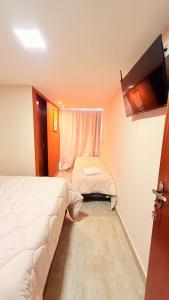 a small room with a bed and a window at CASARÃO SUíTES MARAGOGI in Maragogi