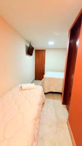 a bedroom with two beds in a room at CASARÃO SUíTES MARAGOGI in Maragogi
