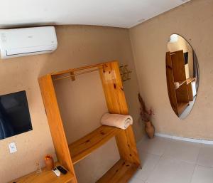 a small bathroom with a mirror and a sink at Chalés Milagres Beach in São Miguel dos Milagres