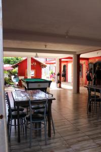 a room with a pool table and some chairs at Pousada NativaMar in Guaratuba