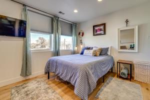 a bedroom with a bed and a large window at Dtwn Walkability! Grand Junction Couple's Retreat in Grand Junction
