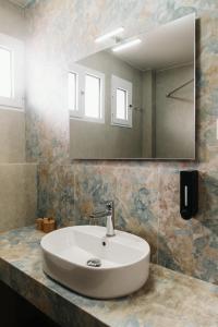 a bathroom with a white sink and a mirror at Deli Home in Kastoria +51 photos