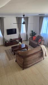 a living room with a couch and a tv at Seasalt & Sand in Mtwapa