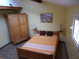 a bedroom with a bed and a wooden door at Les Granges in Villars