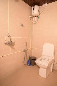 a bathroom with a toilet and a shower at Kieh Beachfront Villa in Mandrem