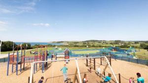 a group of children playing in a playground at Stylish large static caravan gold rated 3BR Slp 8 Thorness Bay in Porchfield