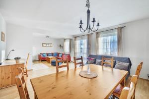 a dining room and living room with a table and chairs at King size apartmán Pension Monika in Špindlerův Mlýn